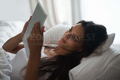 Buy stock photo Tablet, bed and social media with woman in morning to relax, wake up on weekend or reading ebook. Technology, app and internet with young person in bedroom of home for online literature or story