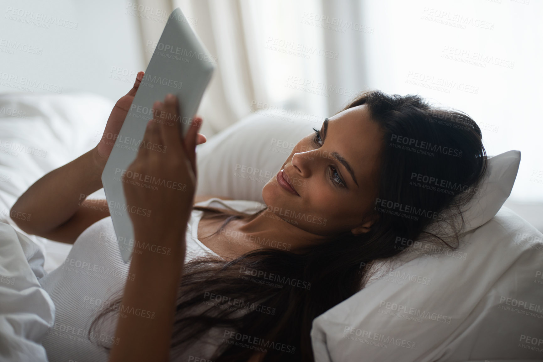 Buy stock photo Tablet, bed and social media with woman in morning to relax, wake up on weekend or reading ebook. Technology, app and internet with young person in bedroom of home for online literature or story