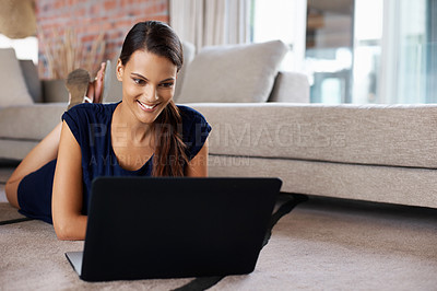 Buy stock photo Laptop, smile and woman relaxing on carpet working on freelance project in living room at home. Happy, technology and female person with computer for creative research laying on floor mat at house.