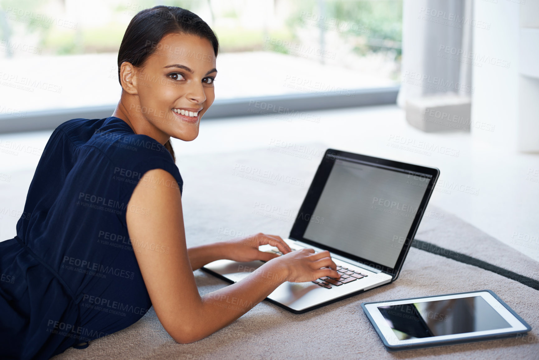 Buy stock photo Laptop, smile and portrait of woman relaxing on carpet working on freelance project at home. Happy, technology and female person with computer for creative research laying on floor mat in living room