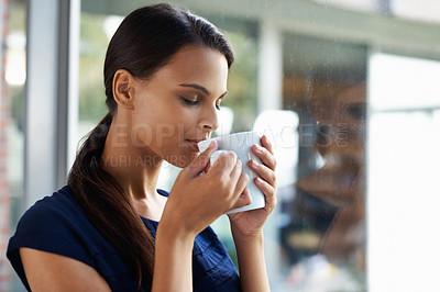 Buy stock photo Woman, relax and drinking coffee in home for peace, calm and energy at breakfast in the morning. Matcha, tea cup and young person with espresso, latte or hot healthy beverage for wellness by window
