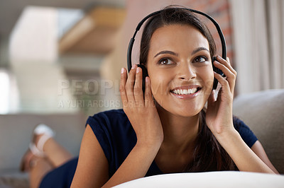 Buy stock photo Face, music and thinking with woman on sofa in living room of home for weekend free time or relax. Smile, streaming and idea with happy young person listening to radio on headphones in apartment