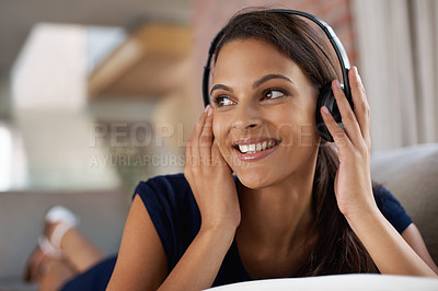 Buy stock photo Face, smile and music with woman on sofa in living room of home to relax on weekend time off. Sound, streaming and headphones with happy young person listening to radio in apartment for break