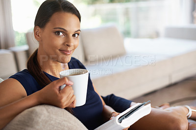 Buy stock photo Portrait, drinking coffee and woman reading book in home to relax, education or learning at breakfast in the morning. Novel, tea cup or face of person with espresso, latte and study on sofa in lounge