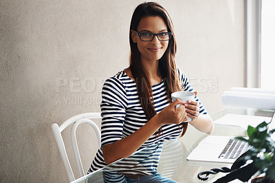 Buy stock photo A young businesswoman having coffee while sitting at her office desk