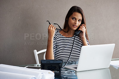 Buy stock photo Telephone call, serious and business woman in conversation, talking or listening to contact with glasses in startup office. Landline, laptop and secretary on phone, receptionist and creative at desk