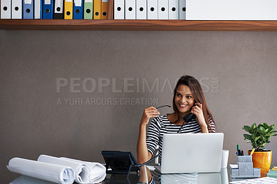 Buy stock photo A young businesswoman talking on the phone while sitting at her office desk