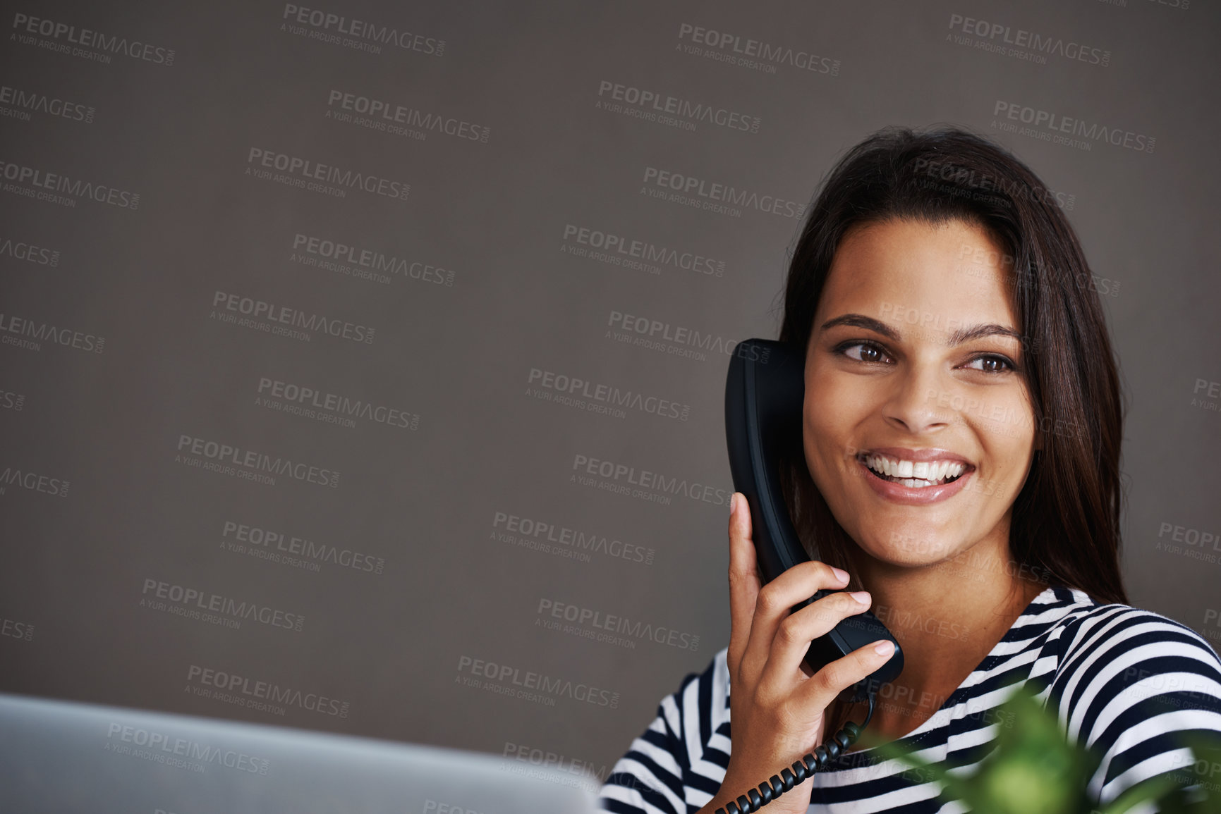 Buy stock photo Telephone call, smile and business woman in conversation, talking or listening to contact in startup office. Landline, happy and secretary on phone, receptionist and creative person with mockup space