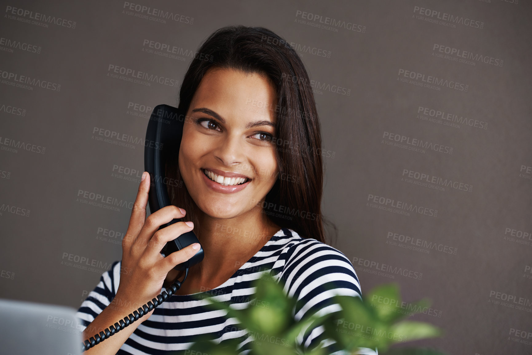 Buy stock photo Telephone call, happy and business woman in conversation, talking or listening to contact in startup office. Landline, smile and secretary on phone, receptionist and creative person with mockup space
