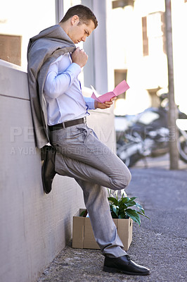 Buy stock photo Businessman, city and unemployment with job loss or stress and thinking of career crisis. Salesman, pink slip and mental health or anxiety in street, reading and fired or termination of work contract