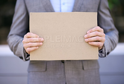 Buy stock photo Unemployment, blank and hands with cardboard, outdoor and adult with poverty as auditor. Person, search and job hunting for work with sign on street in city of Cape Town, career and poster for mockup