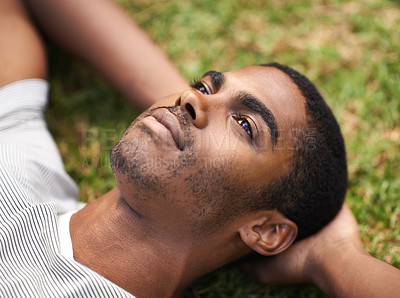 Buy stock photo African man, thinking and relax on grass in nature, idea and vision on summer holiday plan. Thoughtful, enjoying fresh air or reflection, sunshine and peace for freedom after work week on vacation