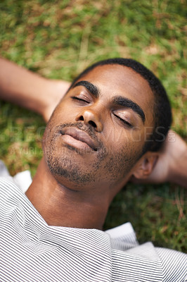 Buy stock photo Black man, relax and laying on grass, nature and summer in garden for vacation mindfulness or stress free. Enjoy, dreaming of future holiday plans, sunshine after work week, calm and rest for freedom
