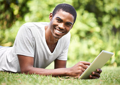 Buy stock photo Portrait, smile and tablet with black man on grass of garden for research or information in summer. Technology, internet and ebook with happy young person lying on green field outdoor in backyard