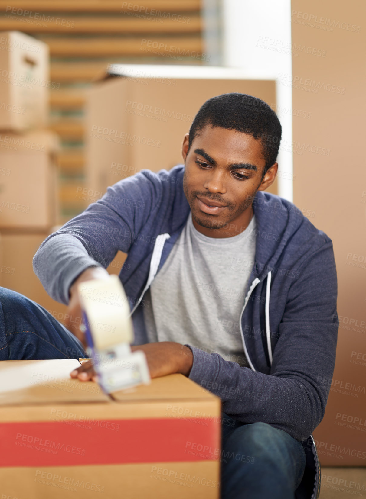 Buy stock photo Home, moving and man packing boxes, shipping and real estate with new property and machine. African person, apartment and guy with a tool for tape and cardboard with package and parcel in a lounge
