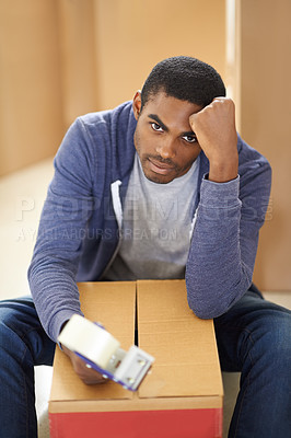 Buy stock photo A handsome young man packing boxes