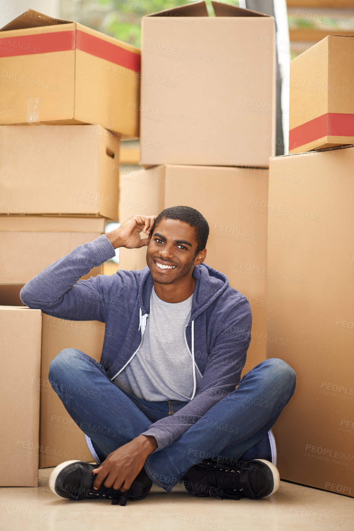 Buy stock photo A handsome young man packing boxes