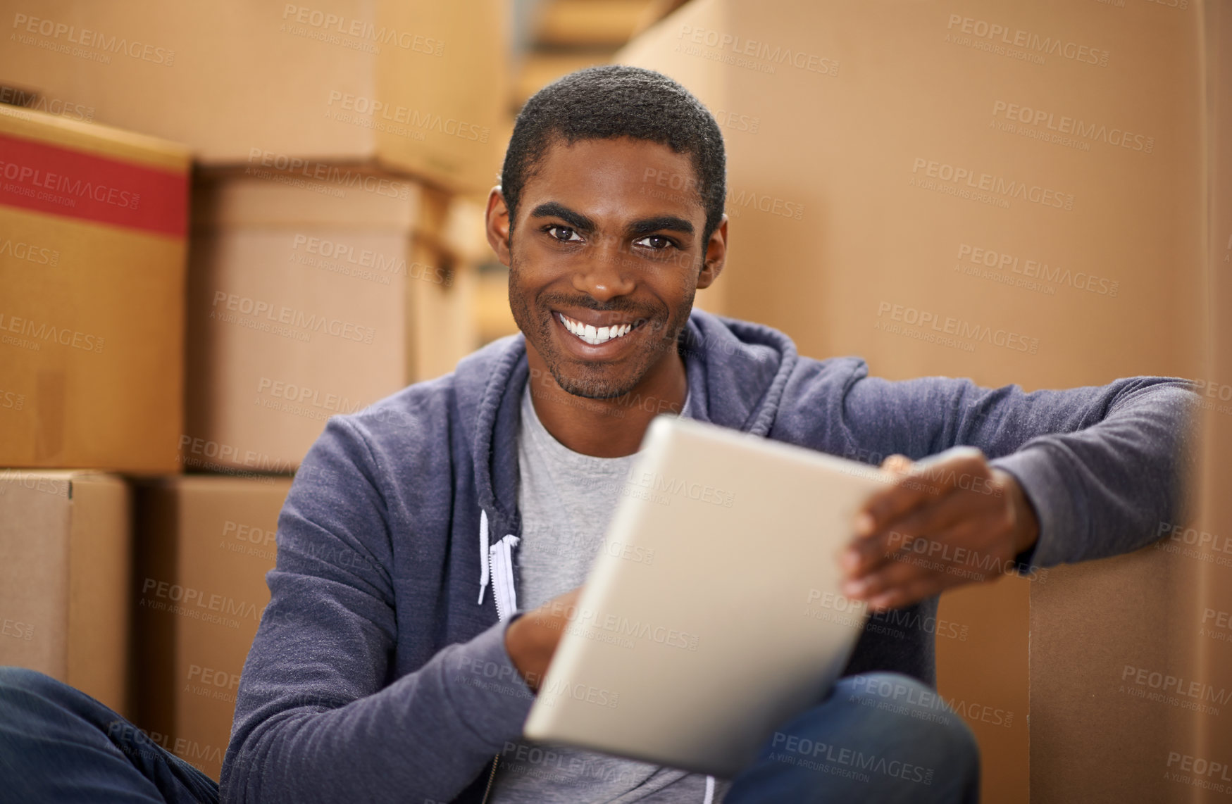 Buy stock photo A handsome young man packing boxes