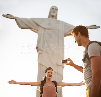 Buy stock photo Shot of a happy young couple taking photos at the Christ the Redeemer statue