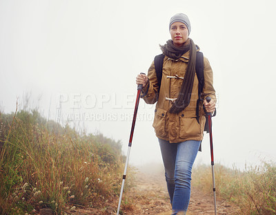 Buy stock photo Woman, hiking and outdoor with trekking sticks, winter and support for fog trail in mountain. Athlete, backpack and sport gear for safety in wet environment, slippery and walking in cold for fitness