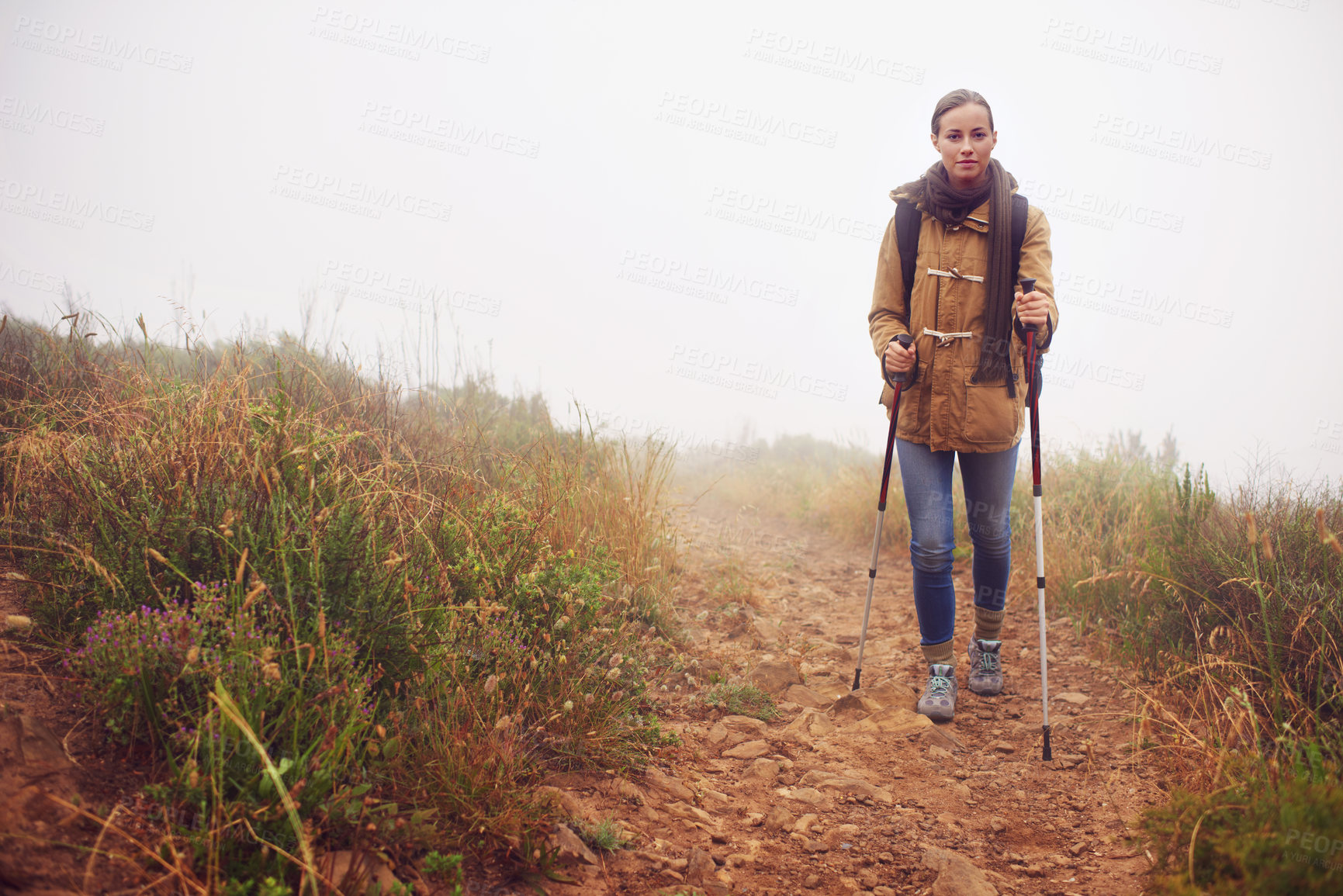 Buy stock photo Woman, hiking and field with trekking sticks, winter and support for fog trail in mountain. Athlete, backpack and outdoor gear for safety in sustainable environment, slippery and walking for fitness