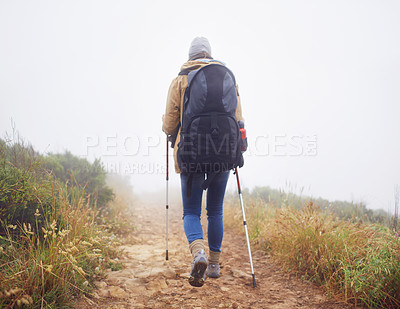 Buy stock photo Person, hiking and back in nature with trekking sticks, winter and support for fog trail in mountain. Athlete, backpack and sport gear for safety in wet environment, slippery and walking for fitness