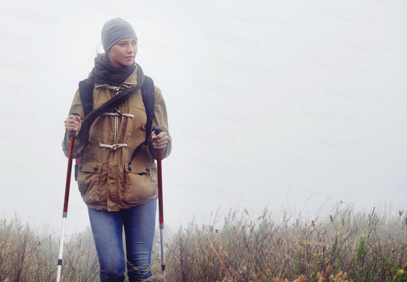 Buy stock photo Woman, hiking and nature with trekking sticks, winter and support for fog trail in mountain. Athlete, backpack and mountaineering gear for safety in wet environment, slippery and walking for fitness
