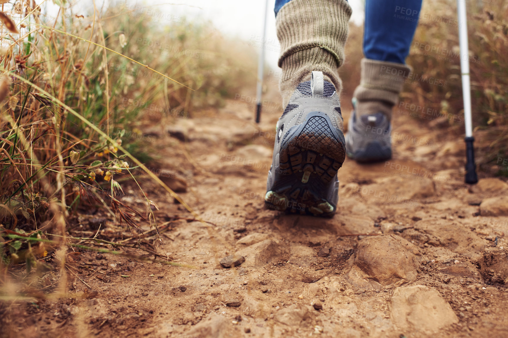 Buy stock photo Cropped rear view of a hiker walking along a trail