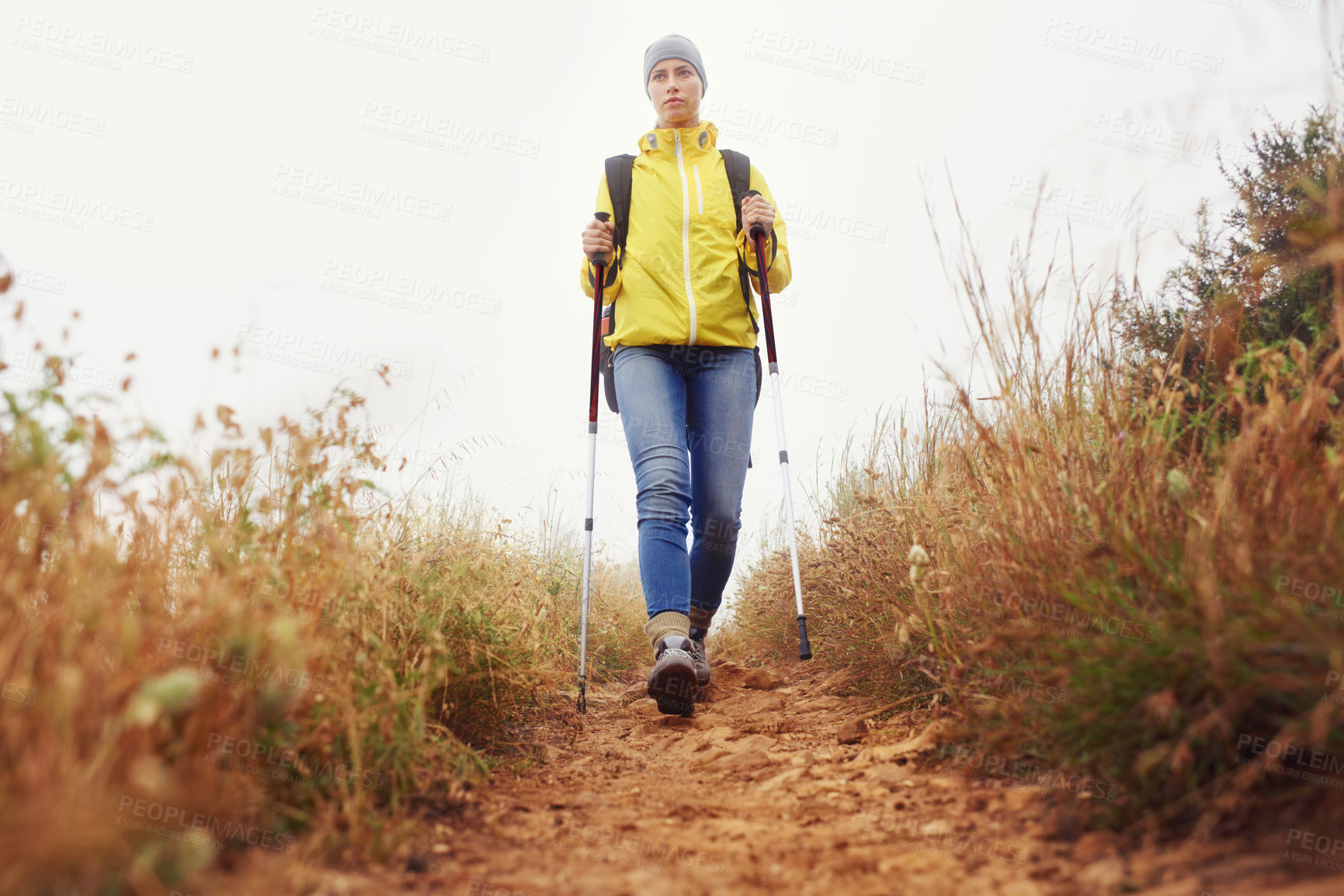 Buy stock photo Hiking, woman and exercise with trekking pole in a bush path or forest trail for walking, workout or fitness on winter morning. Adventure, person or hiker in nature with backpack on holiday or travel