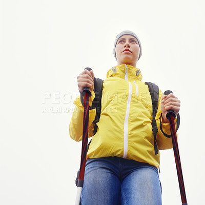 Buy stock photo Woman, hiking and outdoor fitness in nature with gear for travel, adventure and sightseeing in white background. Explore, low angle and person in trekking pole for wellness, health or balance.