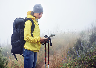 Buy stock photo Woman, hiker and reading map on trail in nature, fog and guide for direction on mountain path. Sports gear in bag for supplies, adventure or fitness with natural winter for health in winter peace