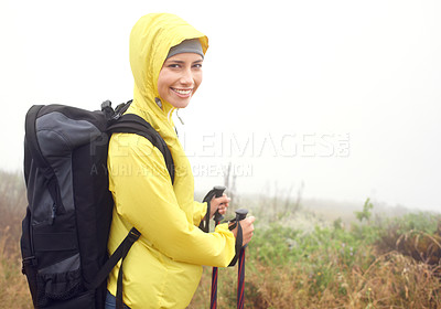 Buy stock photo Portrait, woman hiker and smile on mountain trail, exercise and cardio for fitness in nature. Fog, walking stick and gear for training and morning overcast weather, workout and happy or rest on path