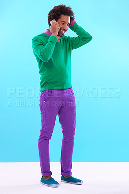 Buy stock photo Fashion, black man and studio in phone call with colorful clothes in blue background for trendy, style and outfit. Male person, stylist and fashionable for trends with smile, funky and edgy.