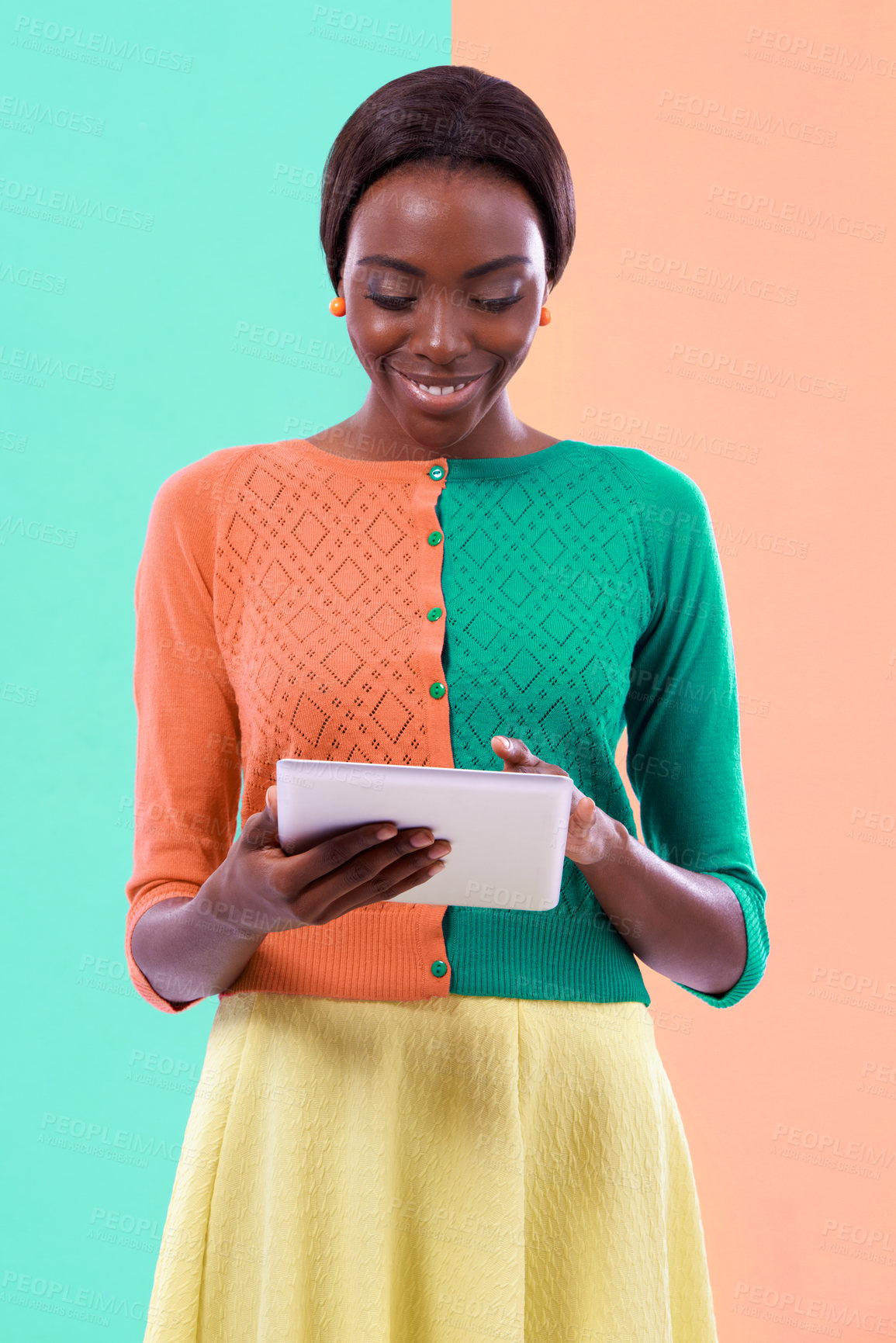 Buy stock photo Black woman, fashion and tablet in studio, smile or happiness with color block background. Stylish, trendy or vibrant female model person, vlogging or blogging in unique clothing for digital hipster