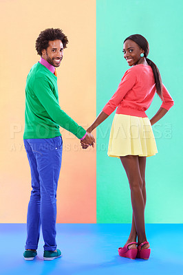 Buy stock photo Fashion, couple and trendy in studio with color clothes, retro and cool with smile and confidence. Black people, man and woman in relationship, hands and stylish or happy in isolated background