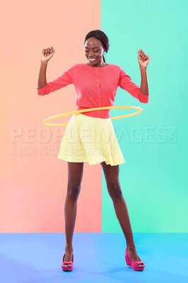 Buy stock photo Woman, smile or hoop for fashion, casual or spring outfit for play or game on color block background. Female person, spinning or plastic toy for funky, colorful or stylish clothing for fun in studio