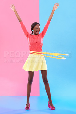 Buy stock photo Woman, smile and hand up for victory, dance and hoop for success on color block background. Winner, female person and spinning of plastic toy to celebrate, achievement or good news in studio