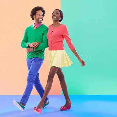 Buy stock photo Happy, couple and walk with fashion in studio, background and creative aesthetic. Excited, woman and man together with colorful retro style, unique clothes or person with support, love and trust