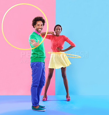 Buy stock photo Couple, fashion and trendy in studio with colour clothes, smile and playful expression on black people together. Artistic, aesthetic in retro style for unique designer, summer fun and hula hoop