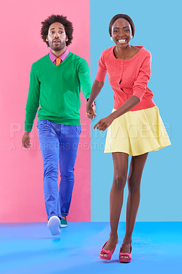 Buy stock photo Couple, walk and holding hands with fashion in portrait, studio or creative aesthetic on background. Excited, woman and man together with colorful retro style, unique clothes or leading with trust