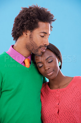 Buy stock photo Hug, love and black couple with marriage, happy and romance on a blue studio background. Relationship, embrace and man with woman and peace with fashion and bonding together with a date and care