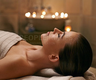 Buy stock photo A young woman lying with her eyes closed on a massage bed