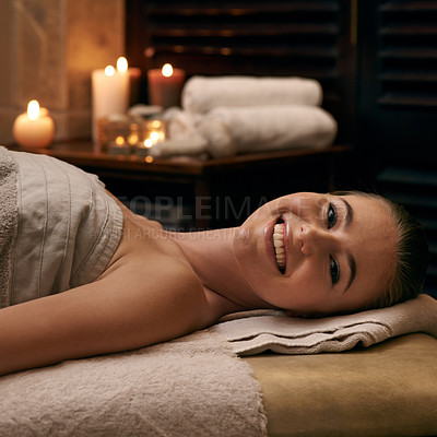 Buy stock photo Happy, woman and portrait on table in spa with candles at night for luxury treatment in hotel on vacation. Girl, relax and smile for cosmetics, skincare and holiday at resort for beauty and wellness