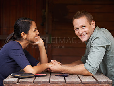 Buy stock photo Love, holding hands and couple at a cafe with support, care and trust while bonding outdoor together. Marriage, romance or portrait of happy man at restaurant with wife for vacation, break or weekend