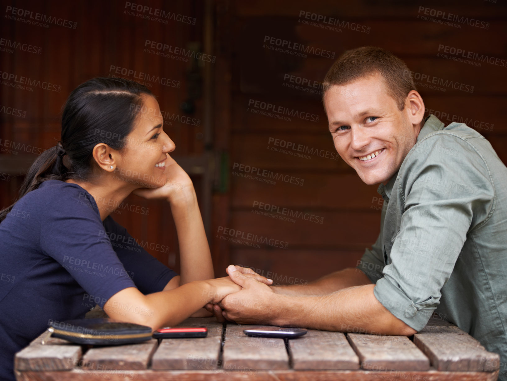 Buy stock photo Love, holding hands and couple at a cafe with support, care and trust while bonding outdoor together. Marriage, romance or portrait of happy man at restaurant with wife for vacation, break or weekend