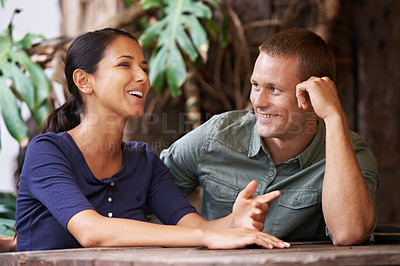 Buy stock photo Love, happy and couple at a cafe for date, bonding and fun gossip, catch up and conversation. Care, romance and people relax at a coffee shop with support, trust and chat, security and listening 