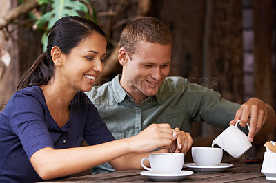 Buy stock photo Shot of a young couple having coffee at a cafe