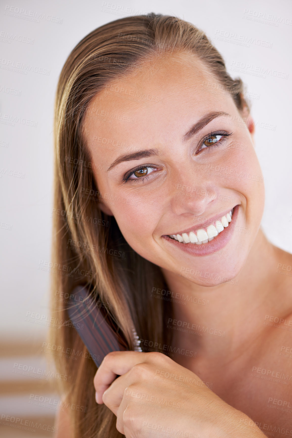 Buy stock photo A gorgeous brunette woman brushing her healthy long hair