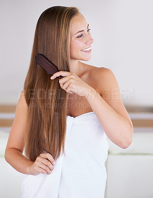Buy stock photo A gorgeous brunette woman brushing her healthy long hair