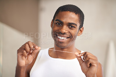 Buy stock photo Portrait, floss and man with smile for grooming, home and cleaning mouth for whitening of teeth. African male person, self care and happiness for health of oral hygiene with tooth treatment string
